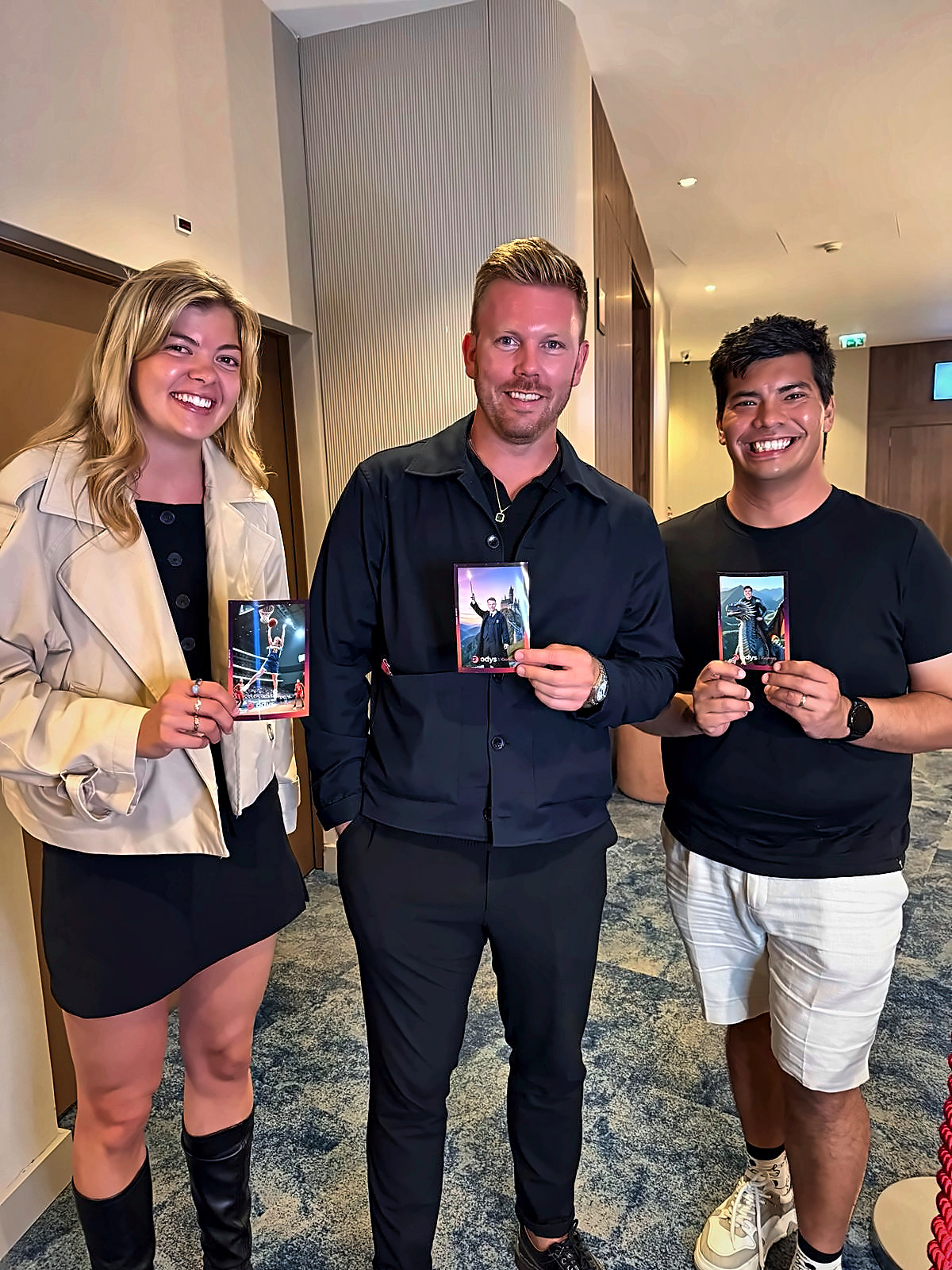 Three guests holding AI photo booth printed cards