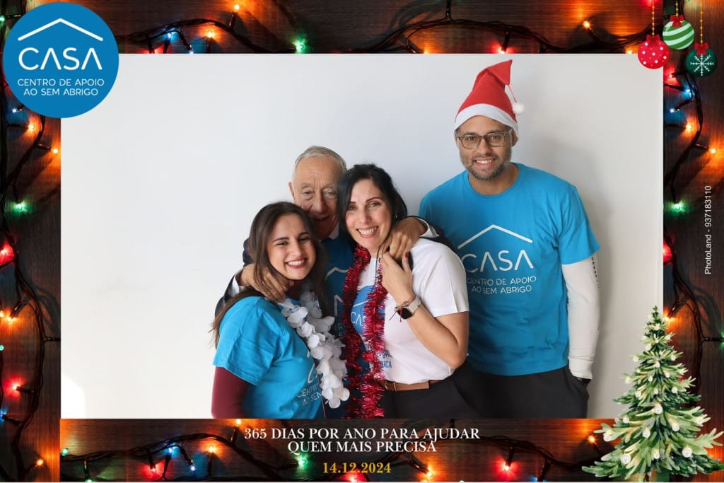 Guests in a PhotoLand photo booth with a custom Christmas frame at a Christmas event in Lisbon