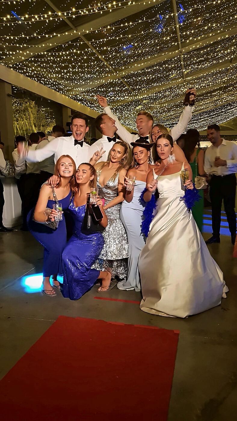Wedding guests posing at a photo booth in Lisbon