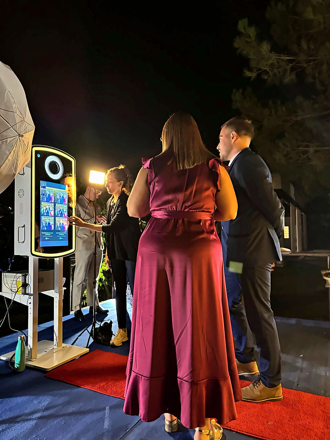 Guests at a night event with a photo booth