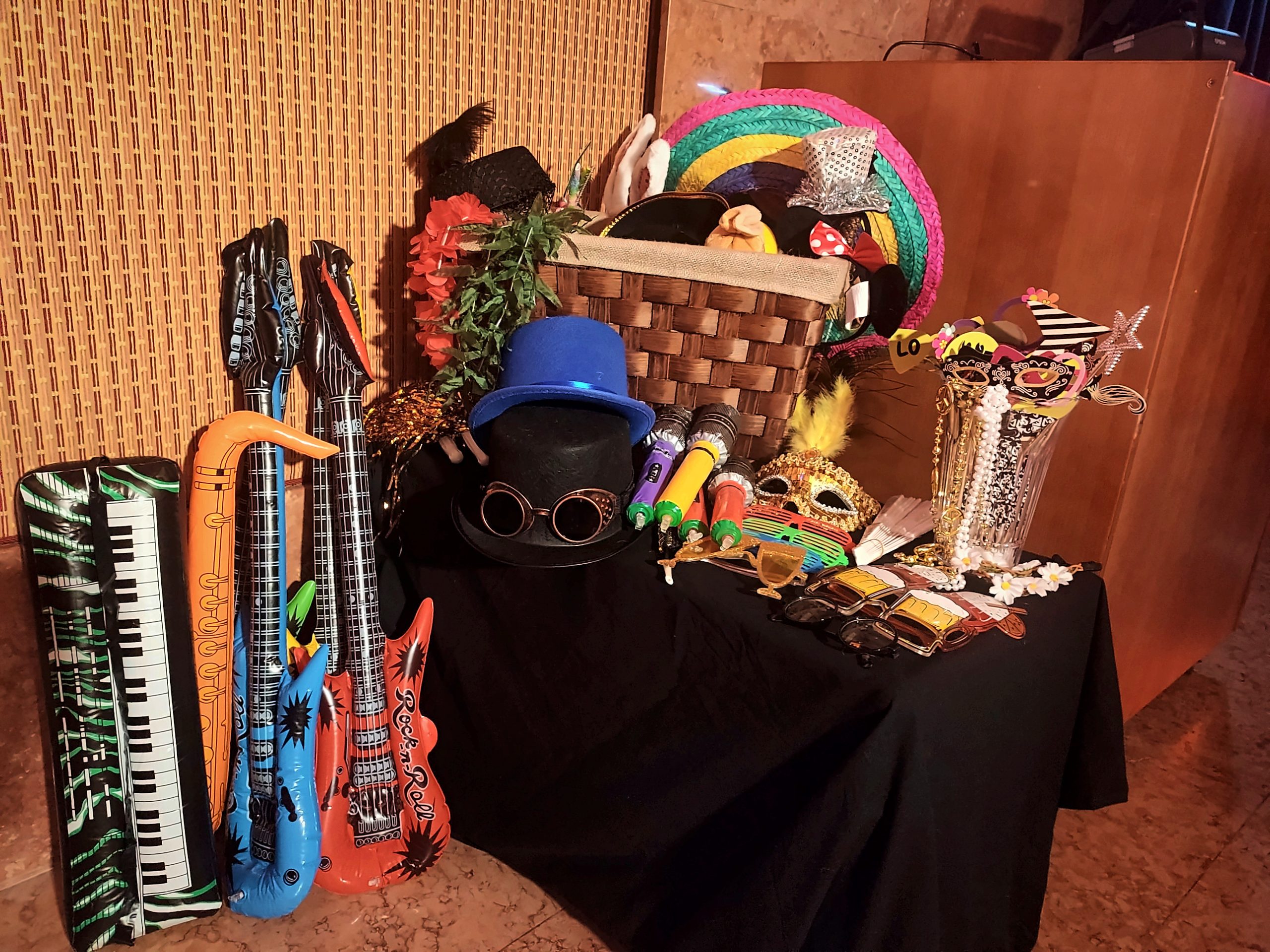 Props table with hats, masks and an inflatable guitar